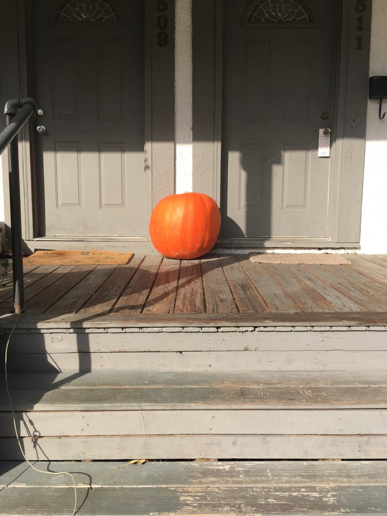 Una calabaza en el porche de una casa
